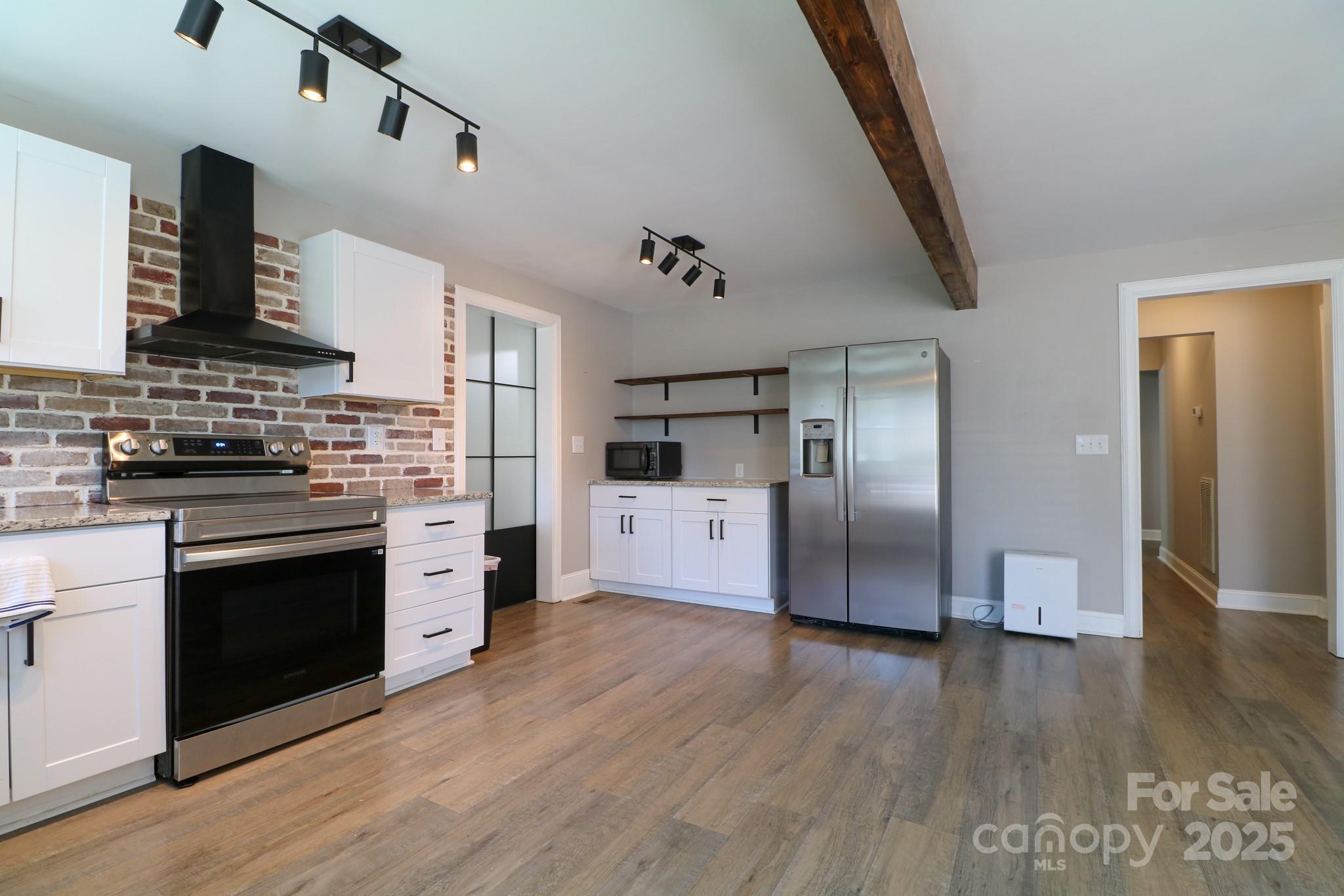 455 Stone Road Salisbury, NC 28146 - Photo 10 of 30 a kitchen with granite countertop a refrigerator and a stove top oven