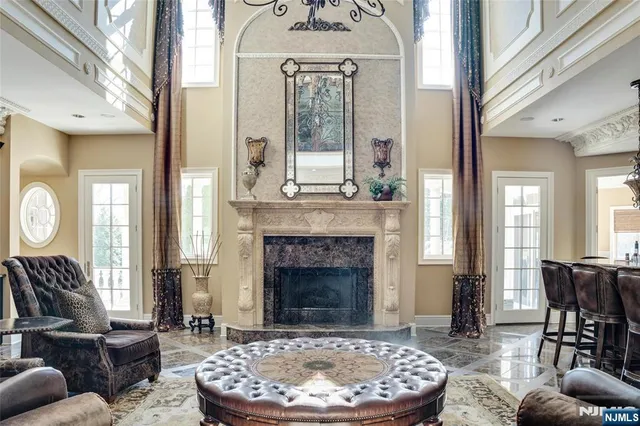 a living room with furniture a fireplace and a large window