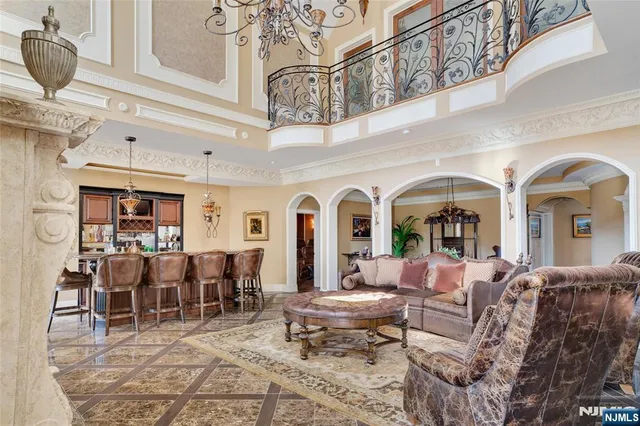 a living room with furniture a chandelier and a rug