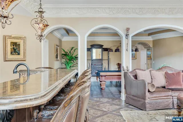 a living room with furniture and a mirror