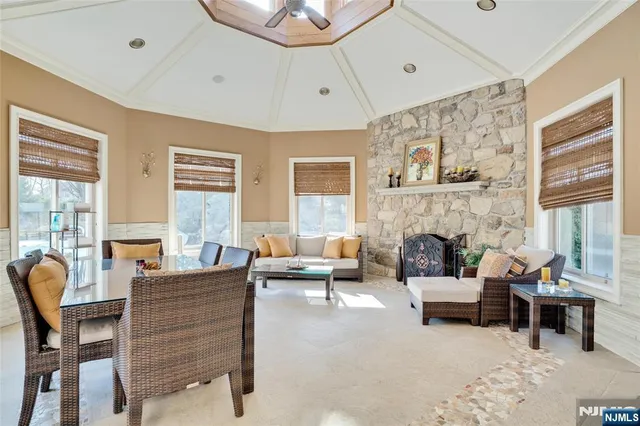 a living room with furniture a fireplace and a large window