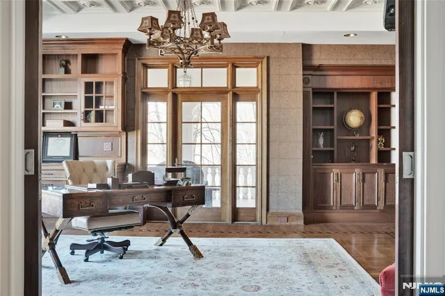 a view of a livingroom with workspace and a window