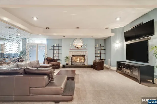 a living room with furniture gym equipment and a flat screen tv