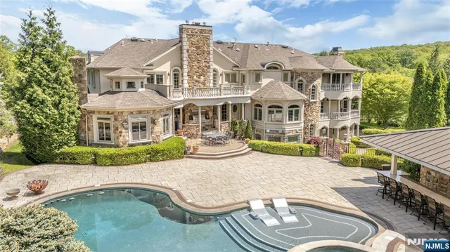 a aerial view of a house with swimming pool and furniture