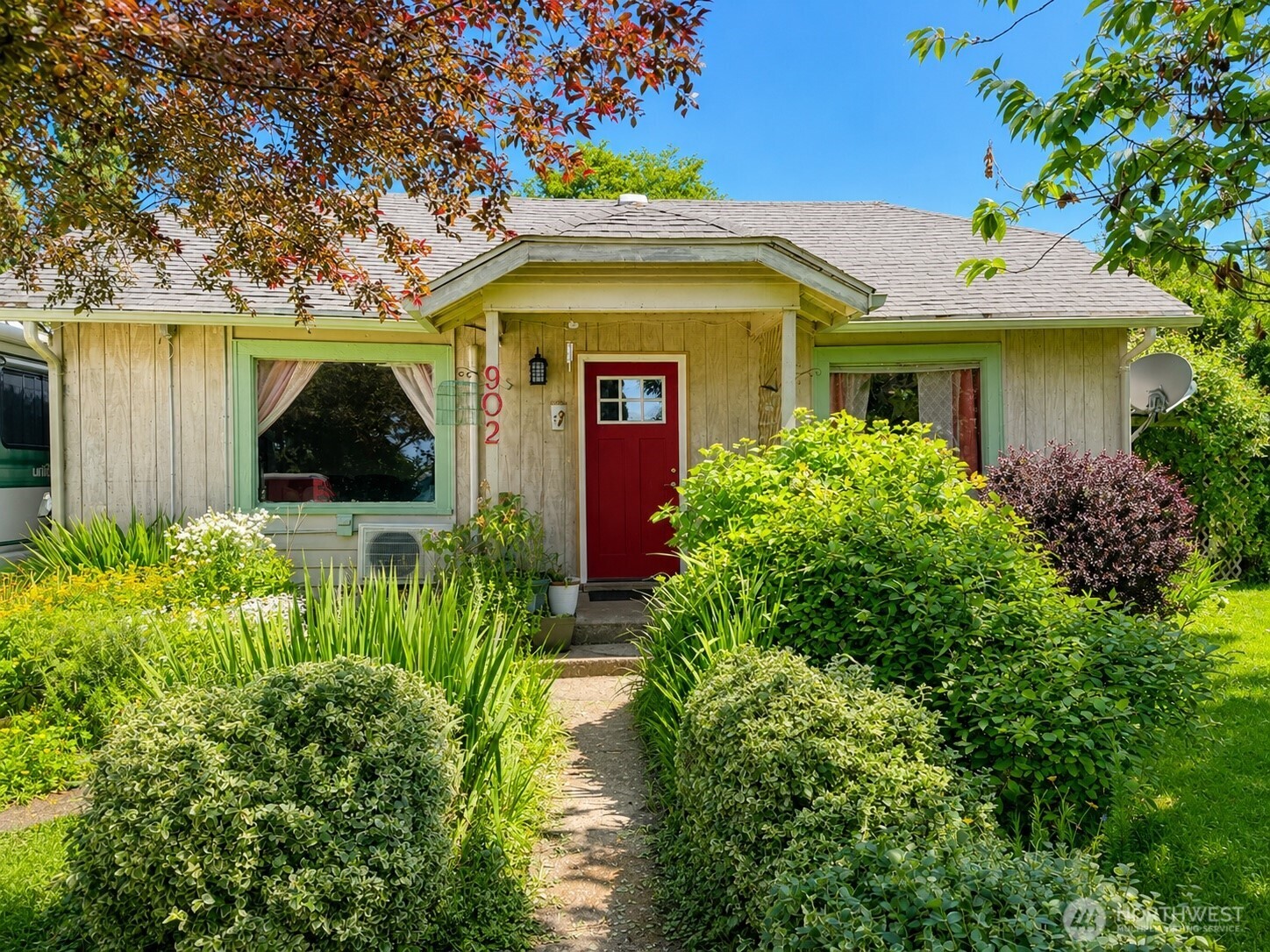 902 Harding Road Aberdeen, WA 98520 - Photo 1 of 18 a view of a house with potted plants and a large tree