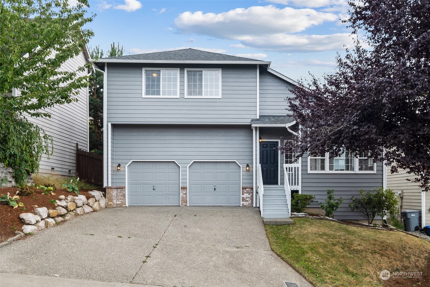 1203 South 35th Street Renton, WA 98055 - Photo 1 of 38 a front view of a house with a yard and garage
