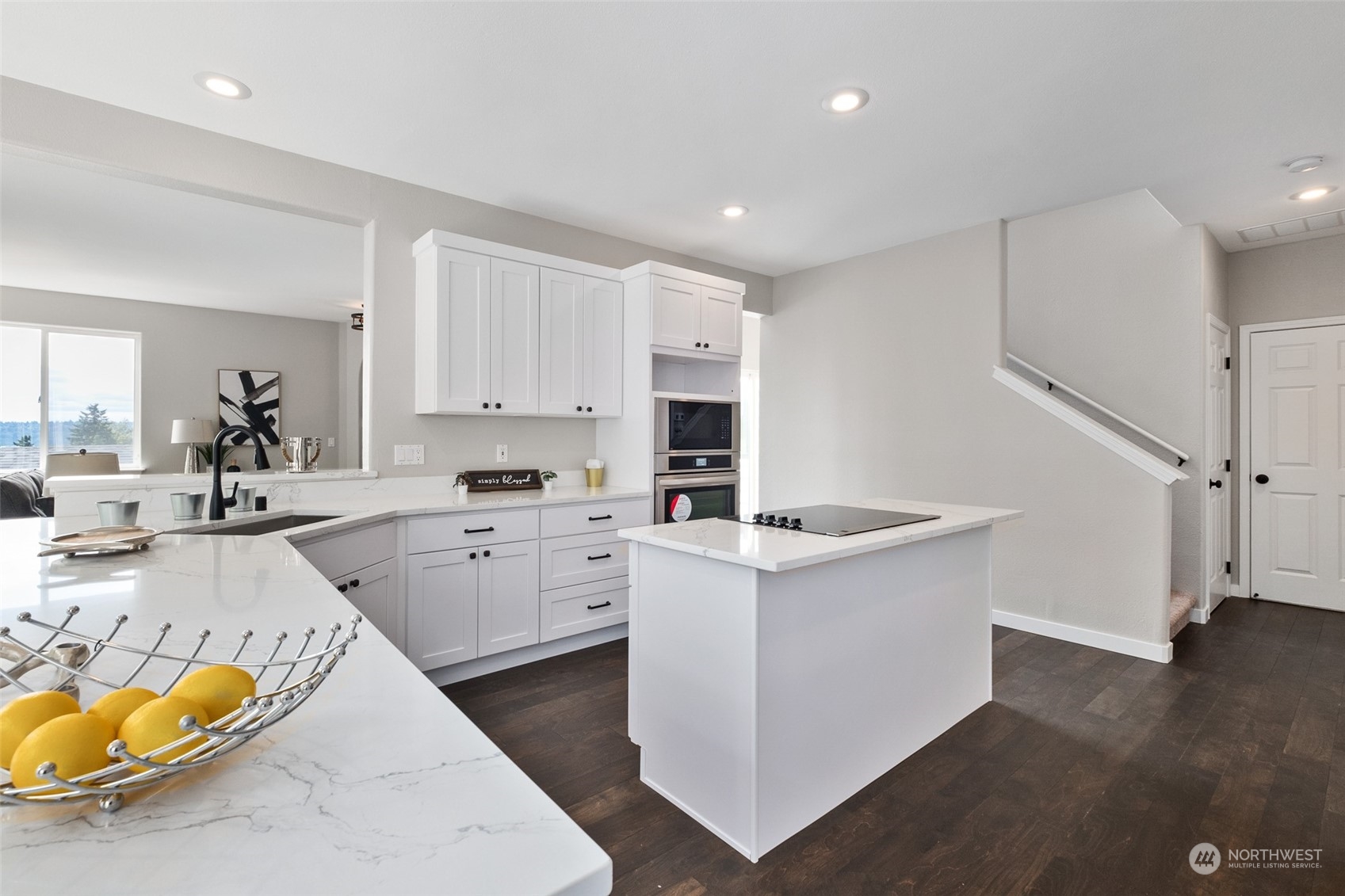 1203 South 35th Street Renton, WA 98055 - Photo 18 of 38 a kitchen that has a lot of cabinets in it and wooden floors