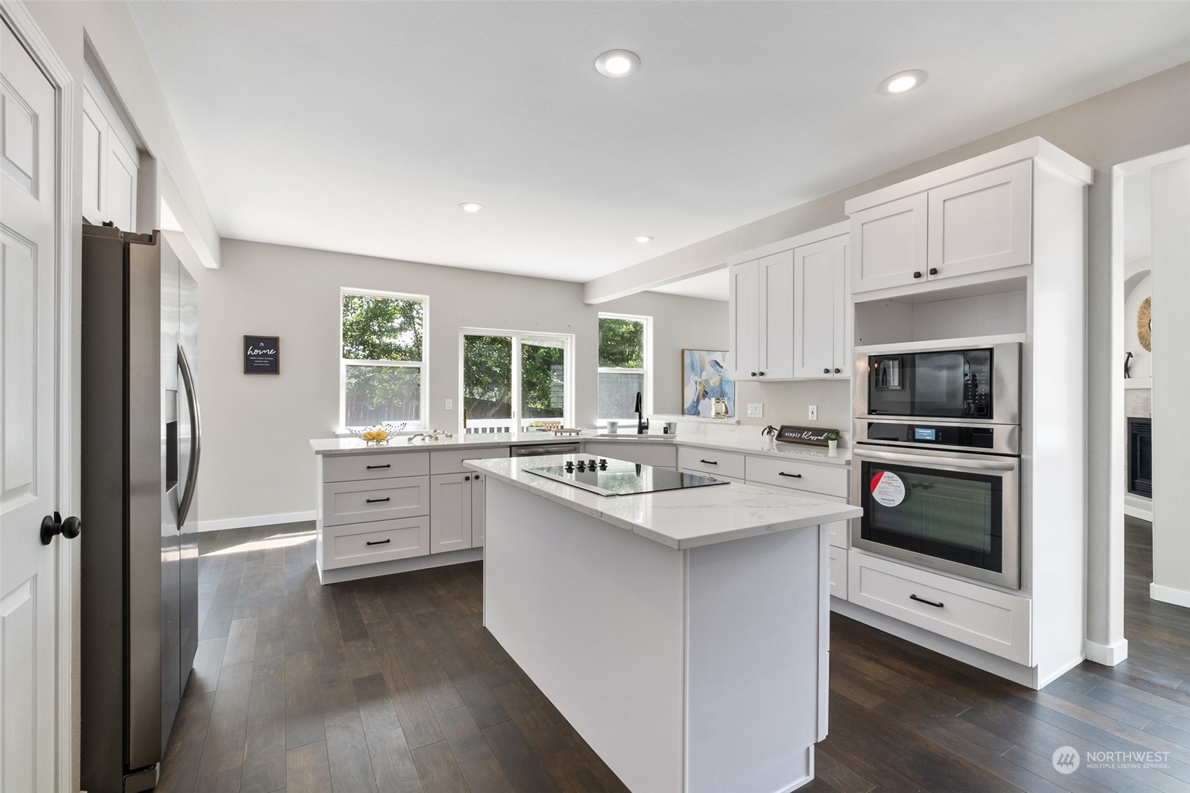 1203 South 35th Street Renton, WA 98055 - Photo 19 of 38 a kitchen with stainless steel appliances kitchen island granite countertop a sink stove and refrigerator