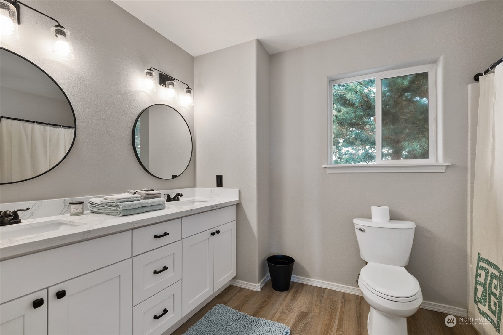 1203 South 35th Street Renton, WA 98055 - Photo 30 of 38 a bathroom with a toilet a double vanity sink and a mirror
