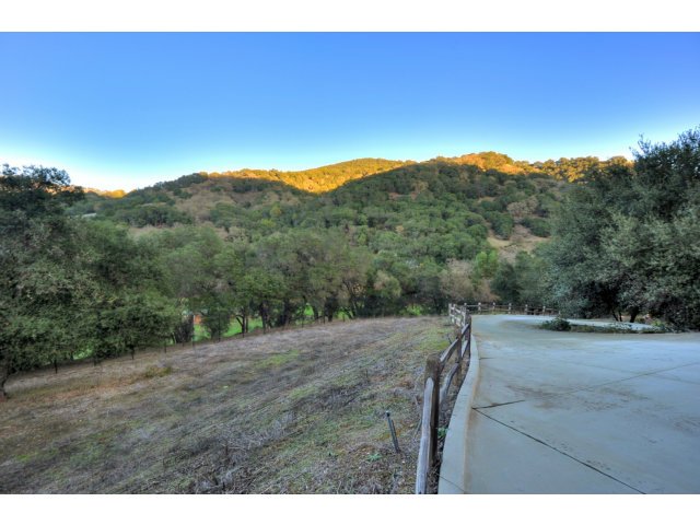 8881 Canada Road Gilroy, CA 95020 - Photo 6 of 24 a view of a dry yard with trees in the background