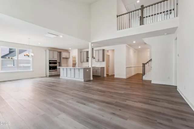 a kitchen with stainless steel appliances cabinets and wooden floor
