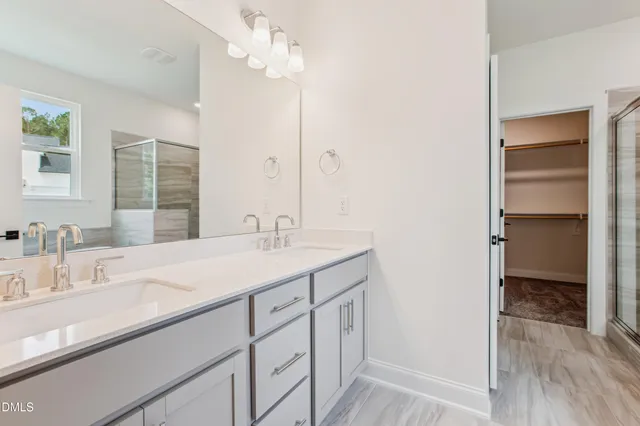 a view of a kitchen with a sink and an empty room