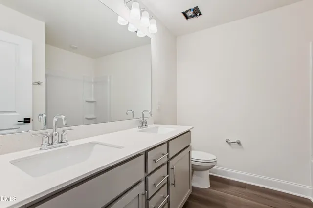a bathroom with a sink double vanity and a mirror
