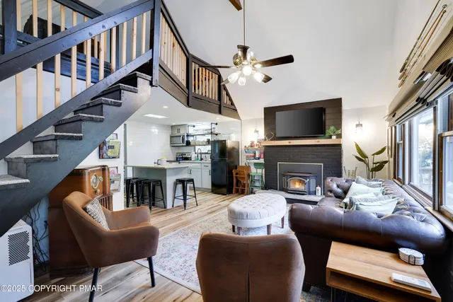 a living room with furniture a table and chairs