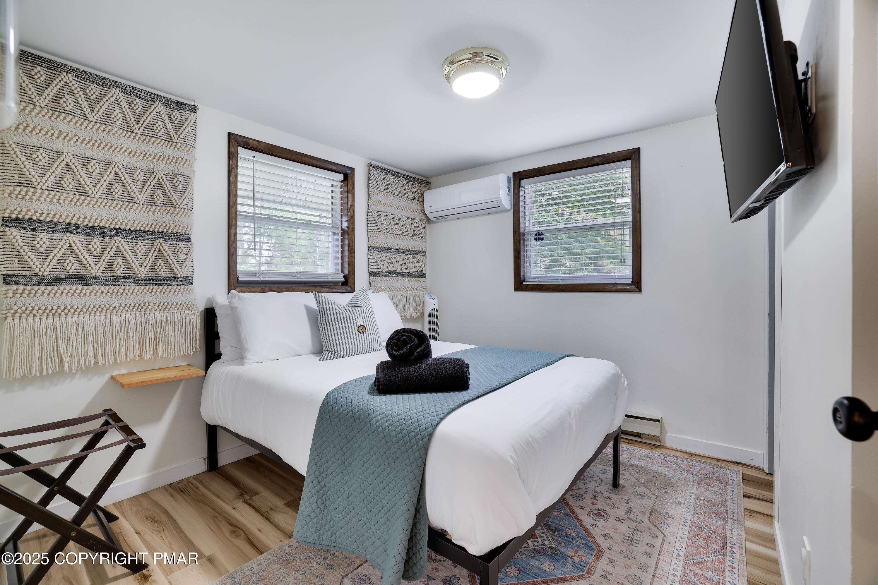 Undisclosed Address Pocono Lake, PA 18347 - Photo 25 of 50 a bedroom with a bed a flat screen tv and a window