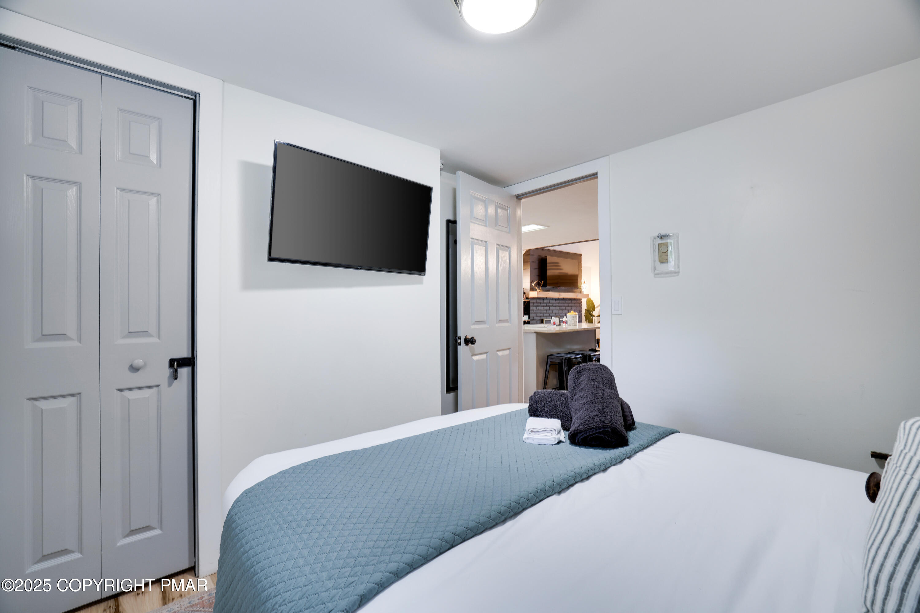 Undisclosed Address Pocono Lake, PA 18347 - Photo 26 of 50 a bedroom with a bed and a flat screen tv