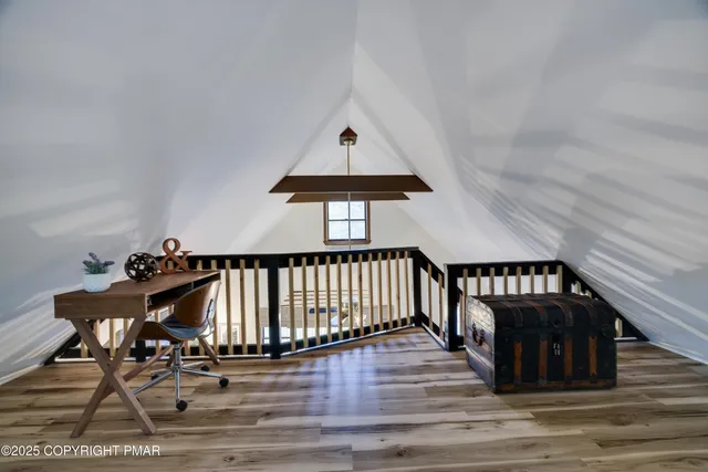 a bedroom with a bed and a lamp on stairs