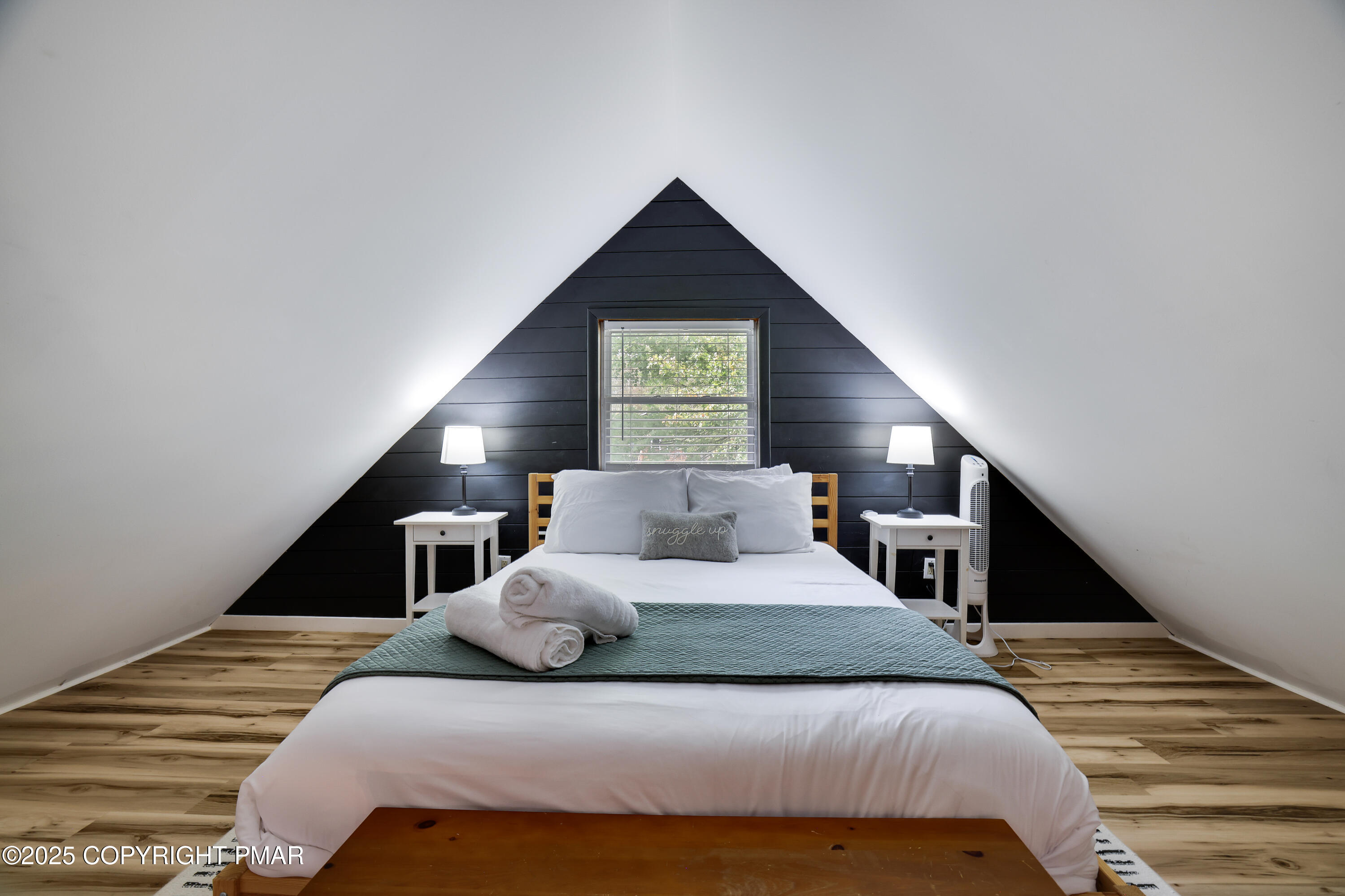 Undisclosed Address Pocono Lake, PA 18347 - Photo 30 of 50 a bedroom with a bed and a lamp on stairs