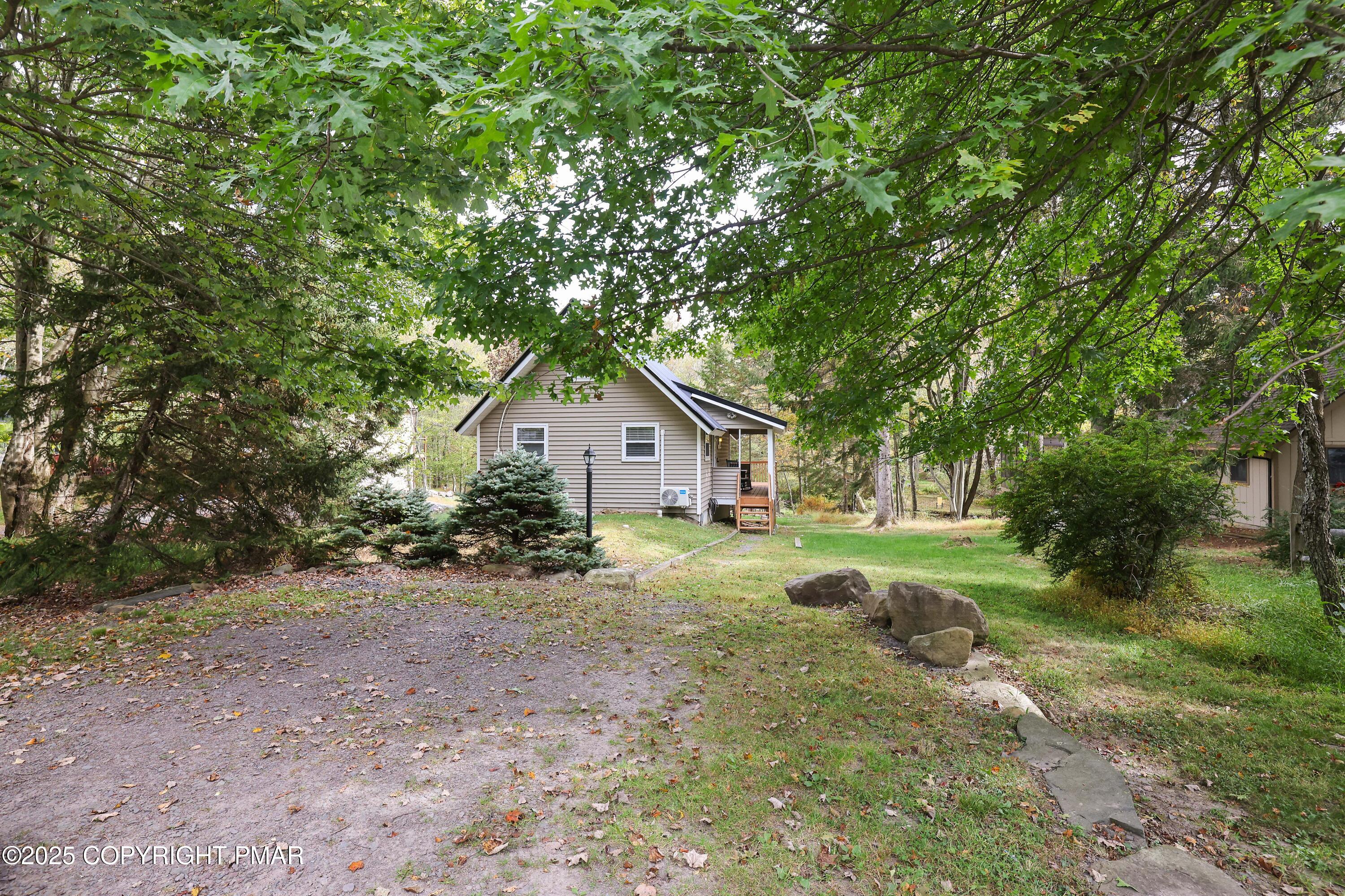 Undisclosed Address Pocono Lake, PA 18347 - Photo 4 of 50 a view of backyard with large trees and plants