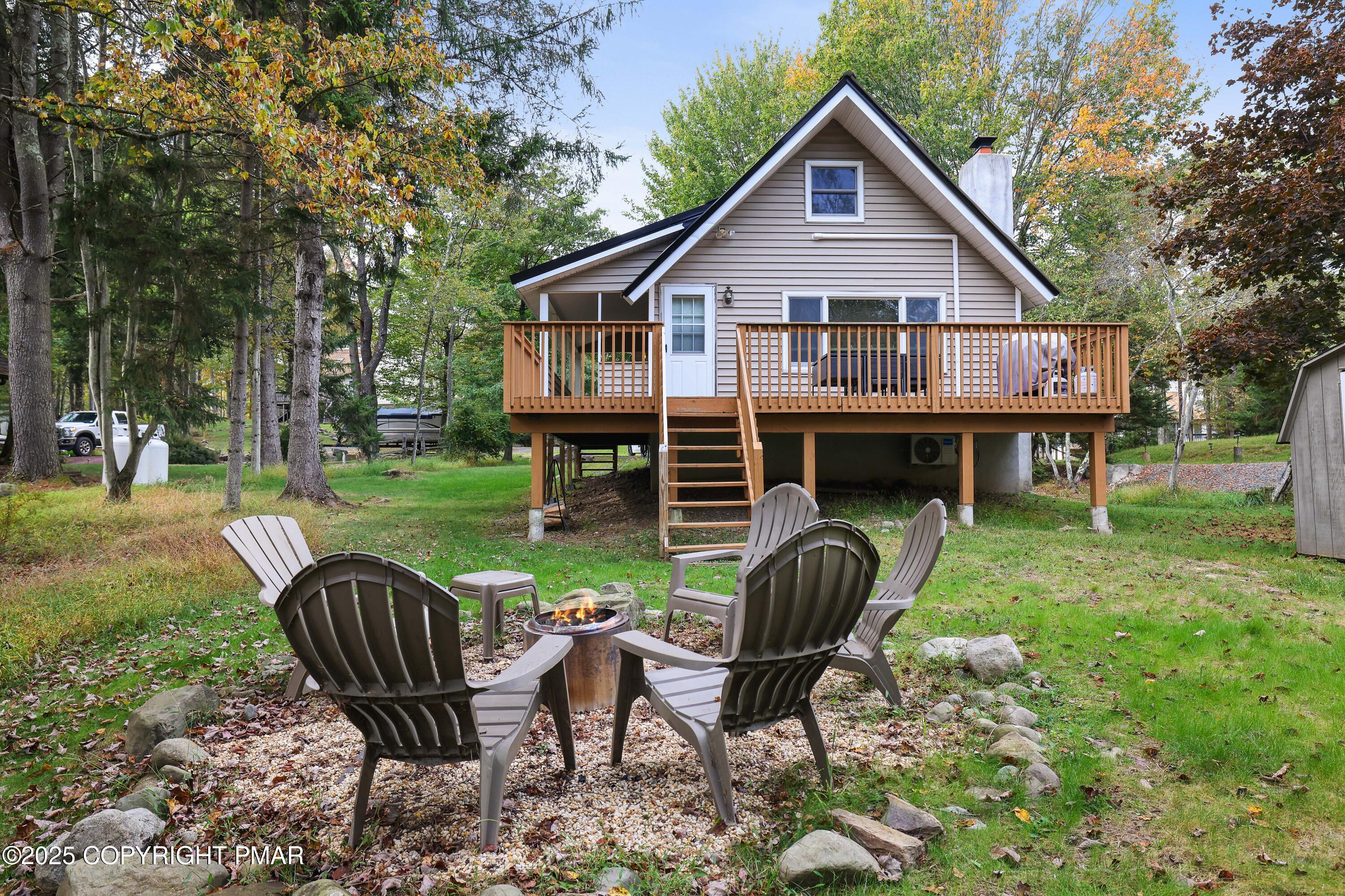 Undisclosed Address Pocono Lake, PA 18347 - Photo 5 of 50 a view of house with backyard and sitting area