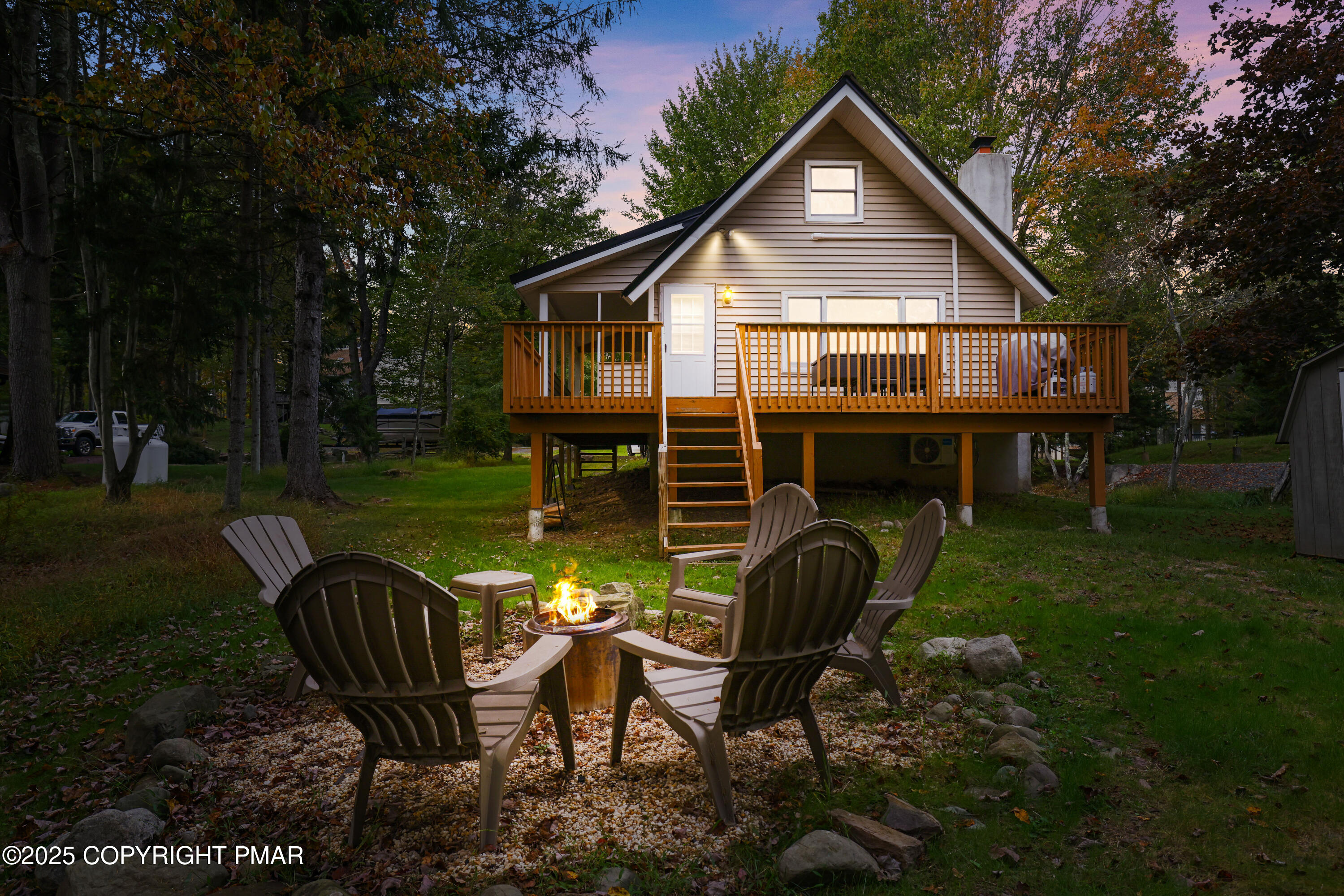 Undisclosed Address Pocono Lake, PA 18347 - Photo 6 of 50 a front view of house with backyard and trees