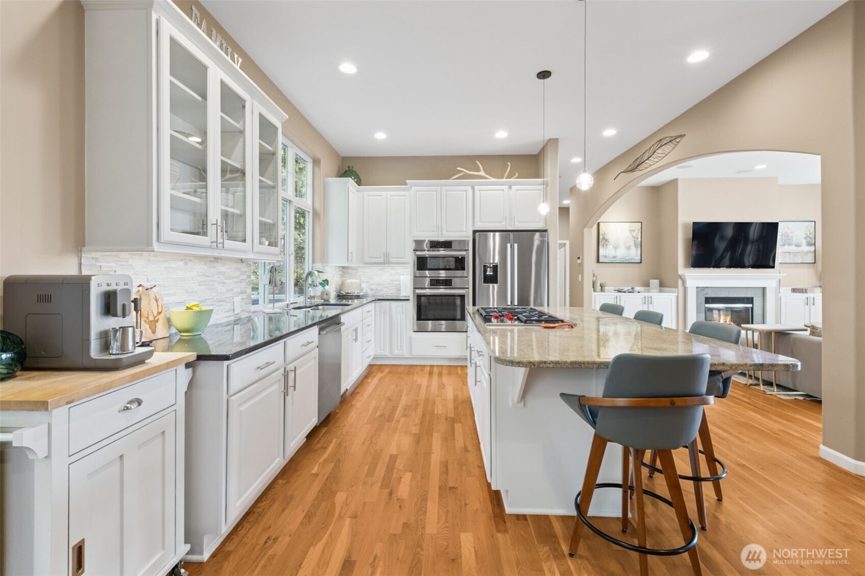 25913 Southeast 159th Street Issaquah, WA 98027 - Photo 12 of 40 a large kitchen with kitchen island a large counter space a sink stainless steel appliances and cabinets