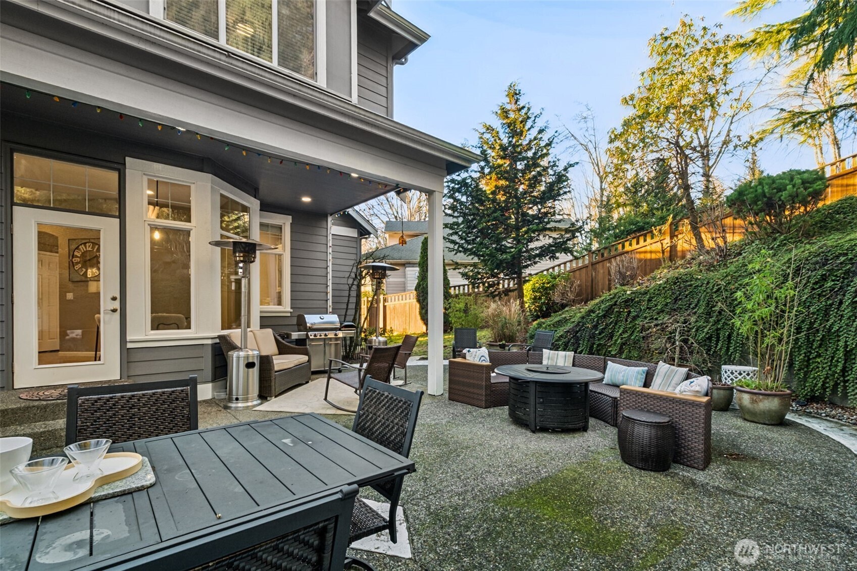 25913 Southeast 159th Street Issaquah, WA 98027 - Photo 34 of 40 a view of a patio with dining table and chairs with wooden floor and fence