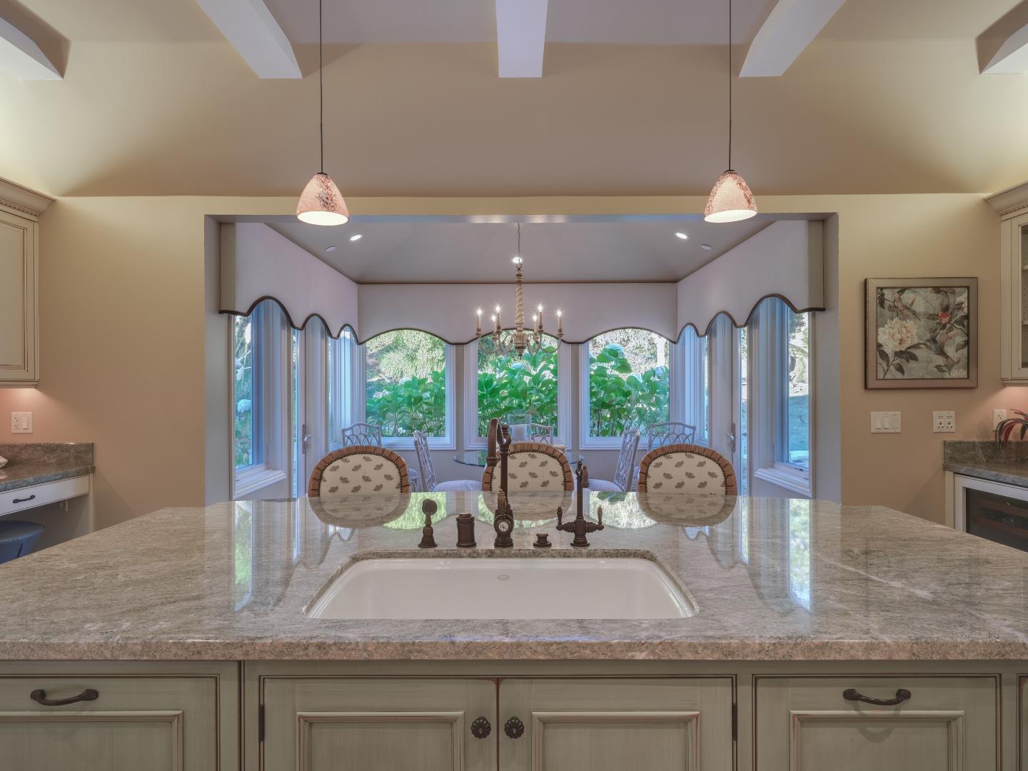 1471 Riata Road Pebble Beach, CA 93953 - Photo 11 of 29 a room with wooden floor table and chairs