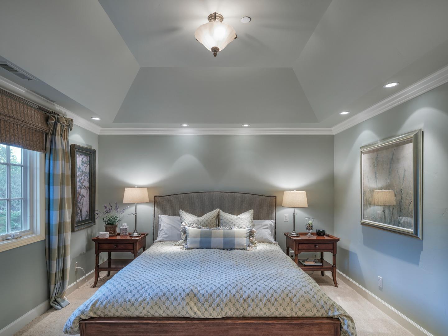 1471 Riata Road Pebble Beach, CA 93953 - Photo 13 of 29 a large bedroom with a bed and wooden floor