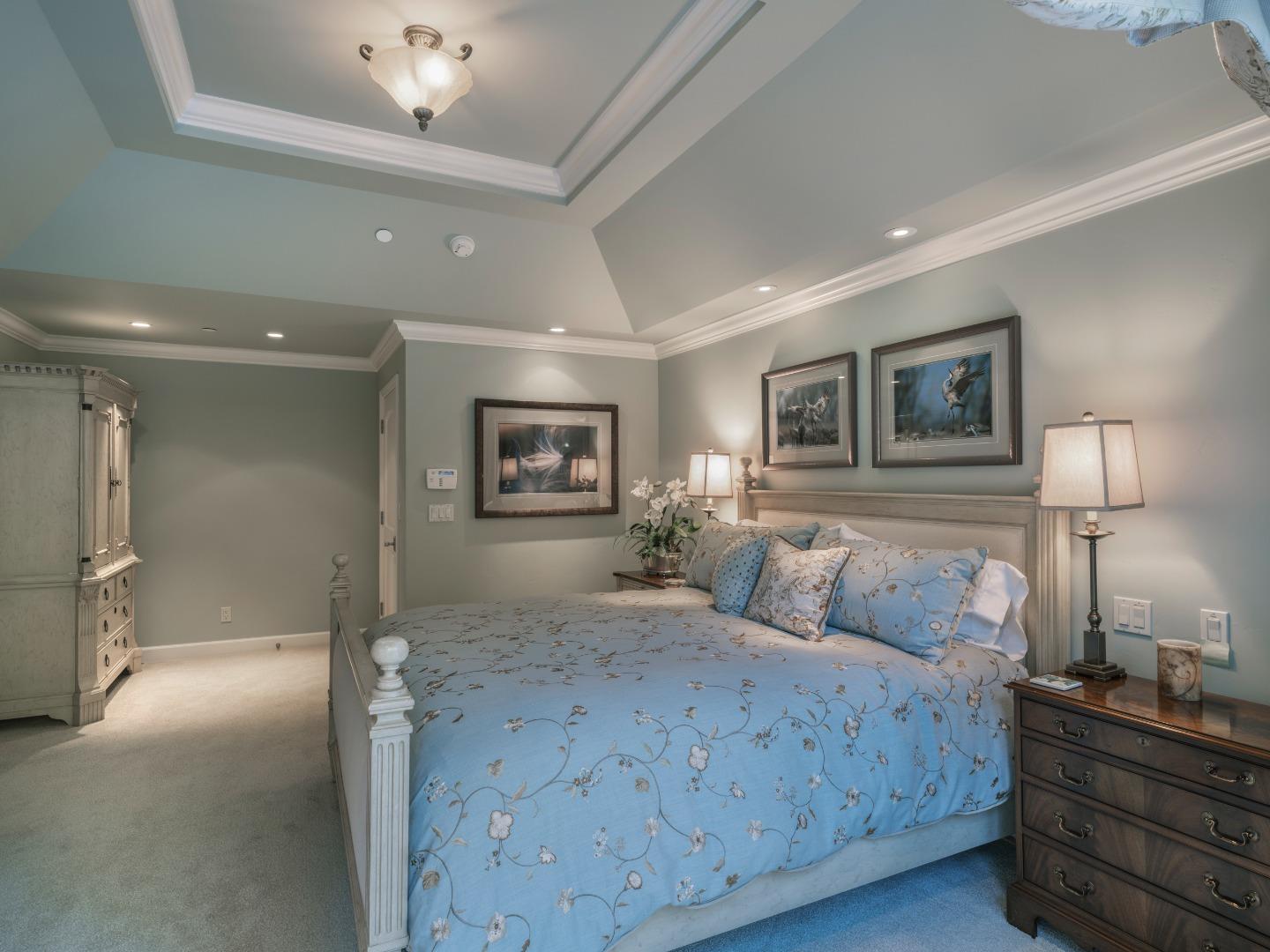 1471 Riata Road Pebble Beach, CA 93953 - Photo 15 of 29 a bedroom with a bed and lamp on dresser