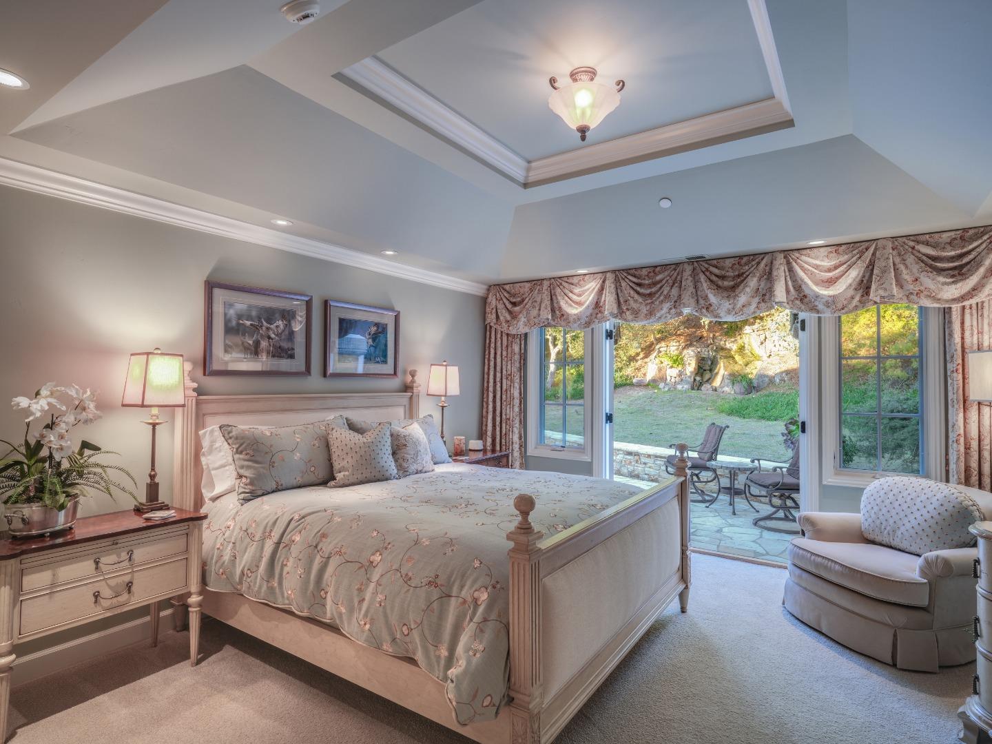 1471 Riata Road Pebble Beach, CA 93953 - Photo 16 of 29 a bedroom with a large bed and a large window
