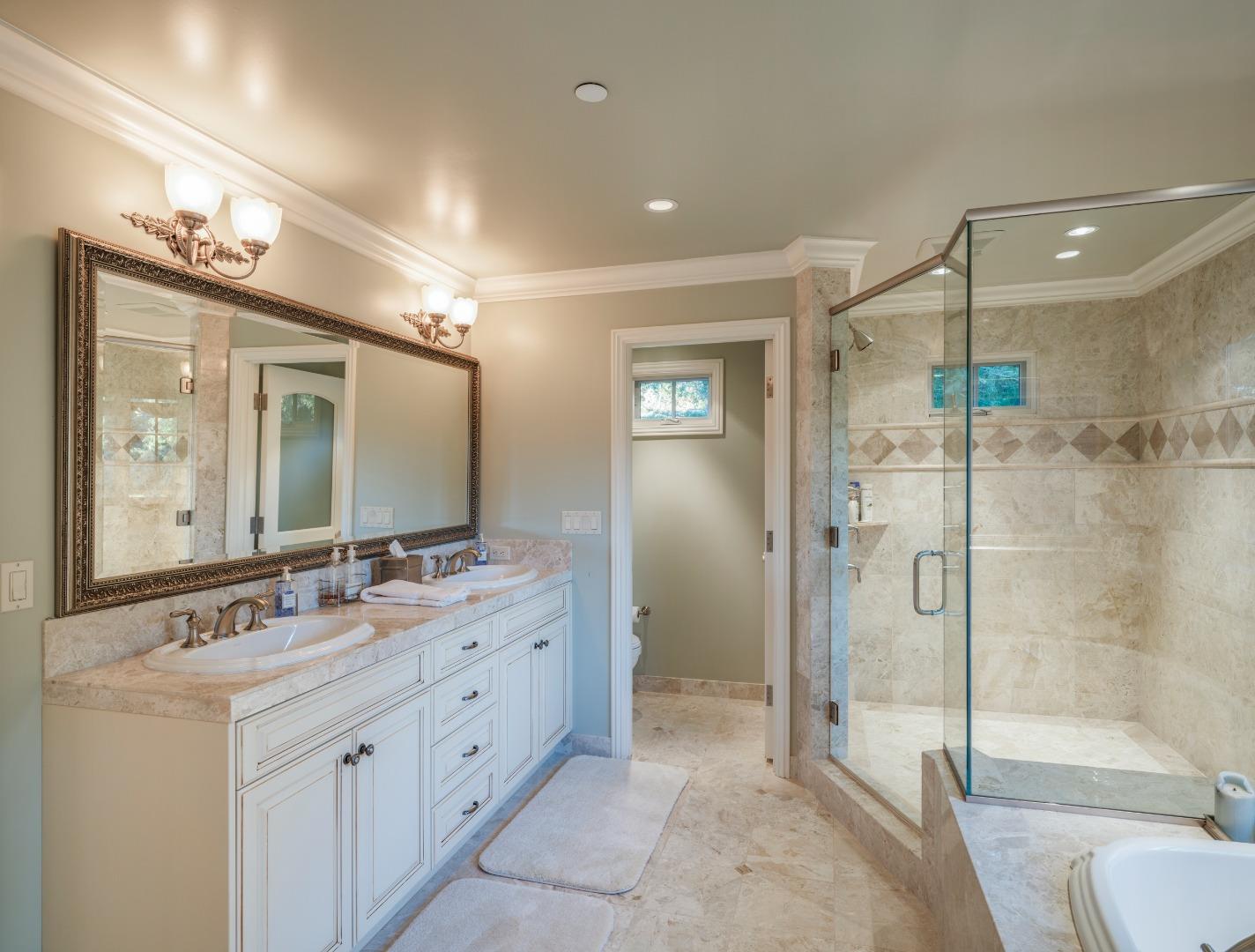 1471 Riata Road Pebble Beach, CA 93953 - Photo 17 of 29 a bathroom with a double vanity sink mirror double and shower