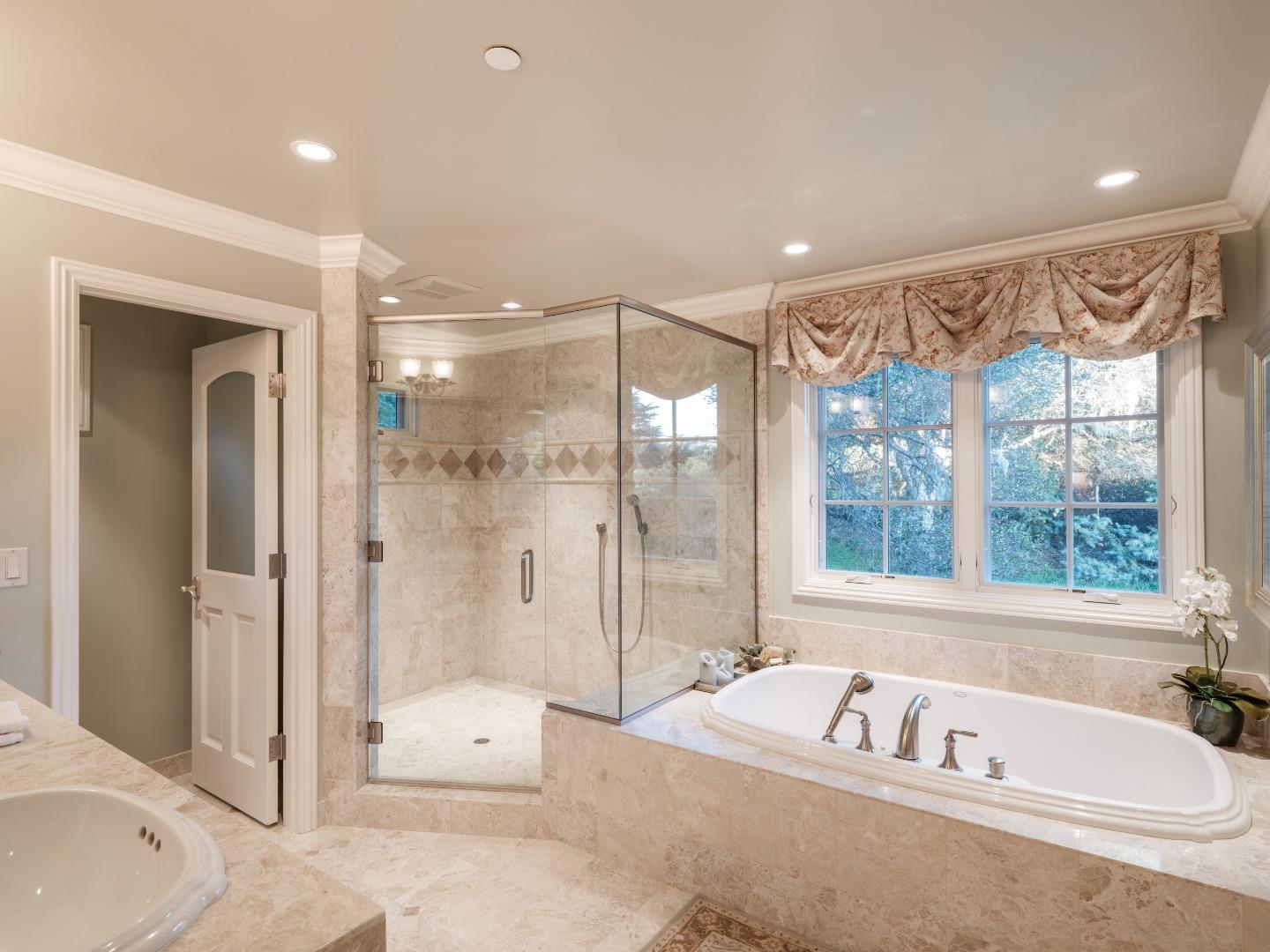 1471 Riata Road Pebble Beach, CA 93953 - Photo 18 of 29 a spacious bathroom with a tub shower and sink