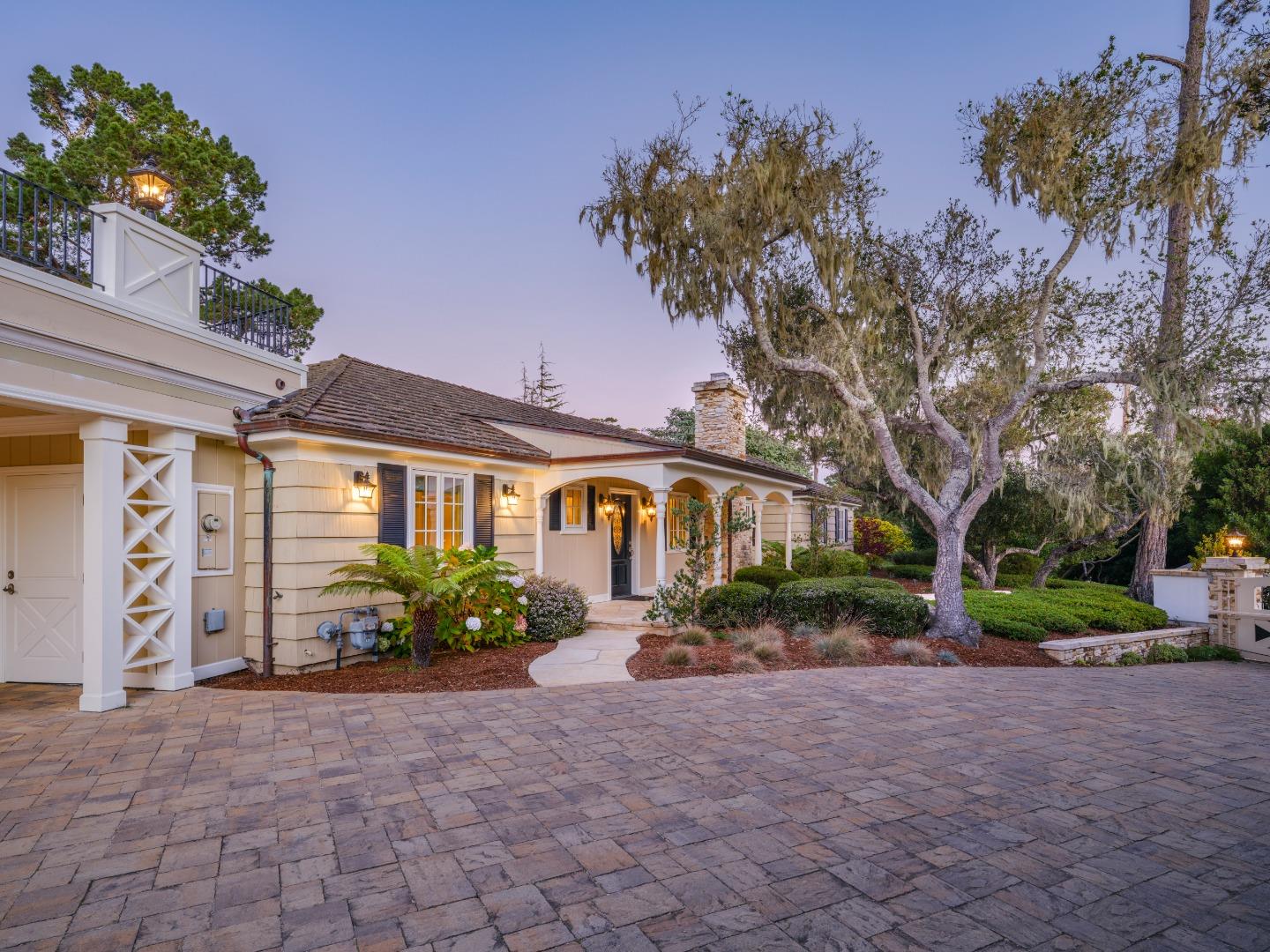 1471 Riata Road Pebble Beach, CA 93953 - Photo 4 of 29 a front view of a house with garden