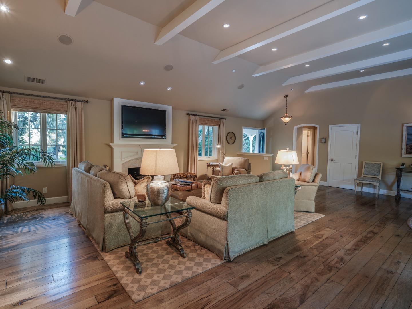 1471 Riata Road Pebble Beach, CA 93953 - Photo 7 of 29 a living room with furniture a flat screen tv and wooden floor