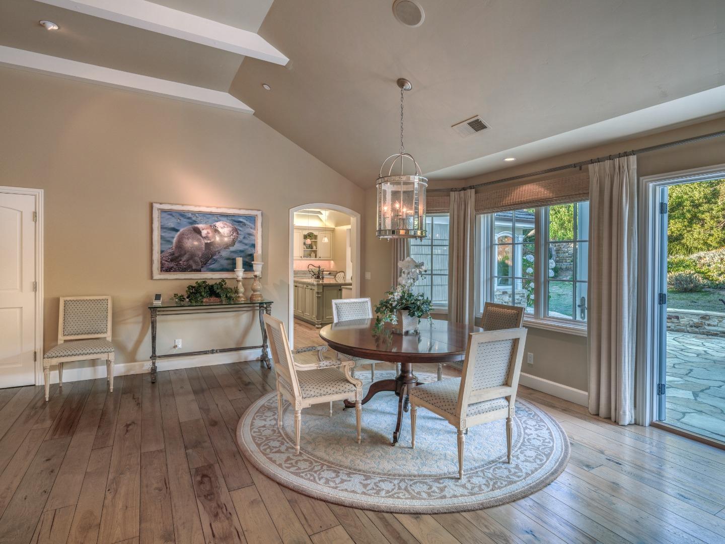 1471 Riata Road Pebble Beach, CA 93953 - Photo 8 of 29 a living room with furniture a large window and wooden floor