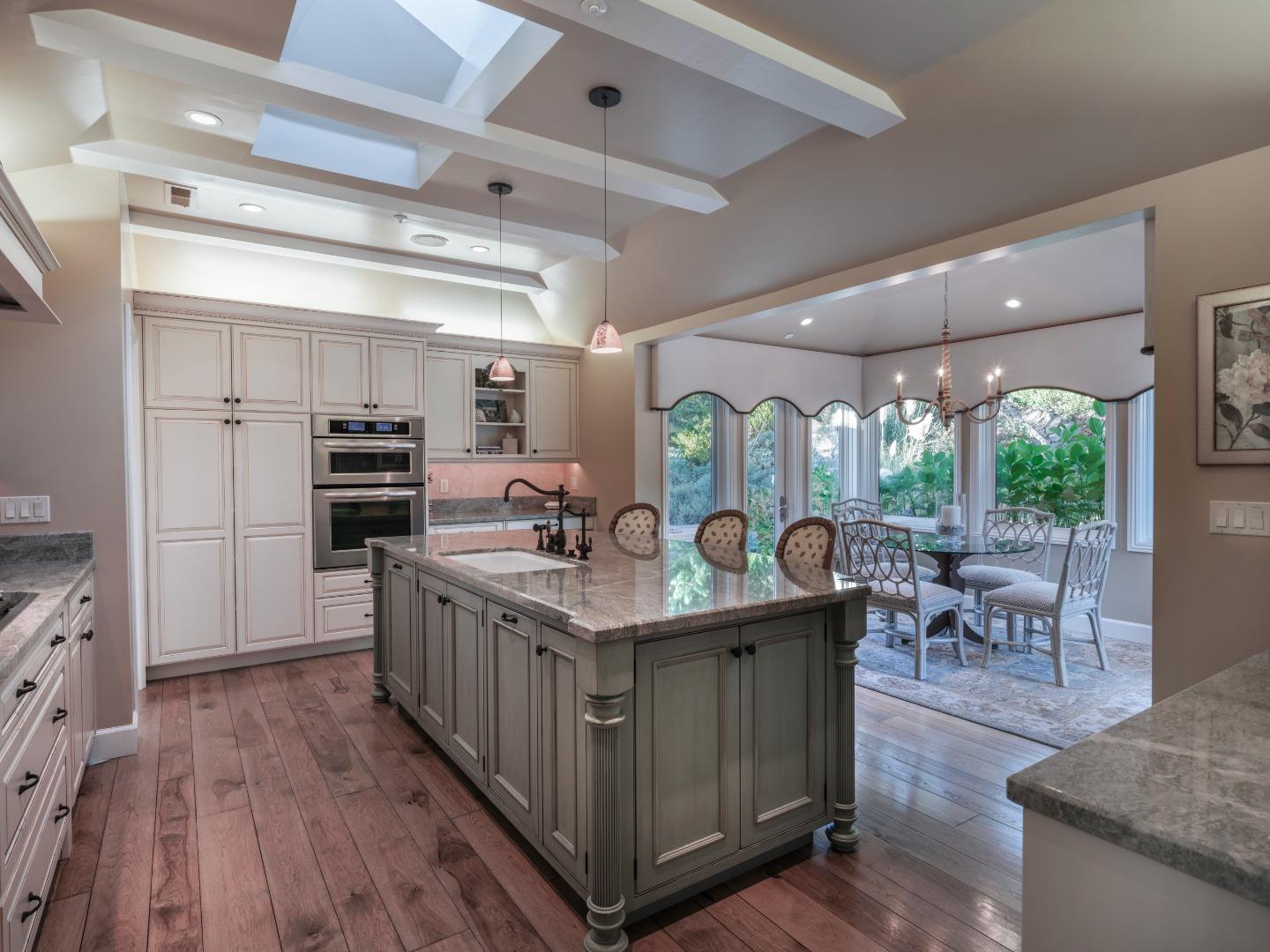 1471 Riata Road Pebble Beach, CA 93953 - Photo 9 of 29 a kitchen with stainless steel appliances granite countertop a lot of counter space and wooden floors