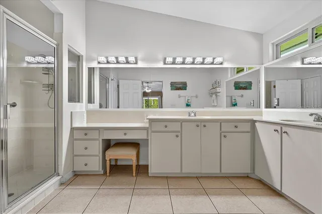 a spacious bathroom with a granite countertop sink mirror and a