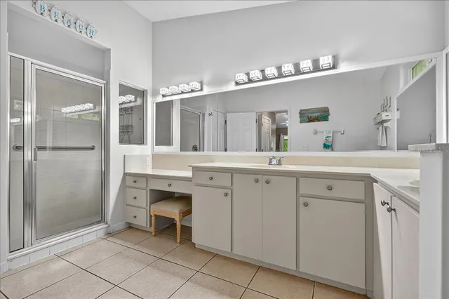 a spacious bathroom with a double vanity sink a mirror and a shower