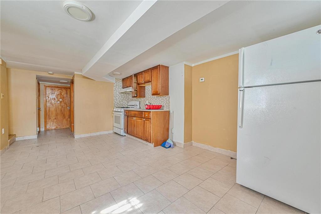 1270 68th Street Brooklyn, NY 11219 - Photo 11 of 20 a view of kitchen and empty room with windows