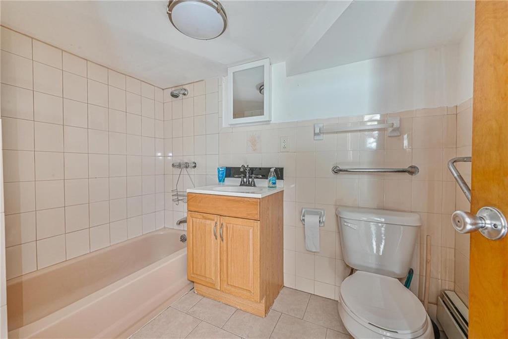 1270 68th Street Brooklyn, NY 11219 - Photo 16 of 20 a bathroom with a granite countertop toilet sink and shower