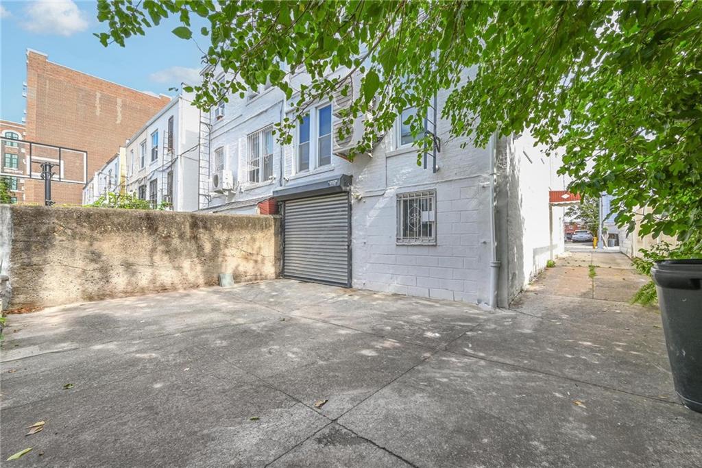 1270 68th Street Brooklyn, NY 11219 - Photo 18 of 20 a view of a house with a tree in front