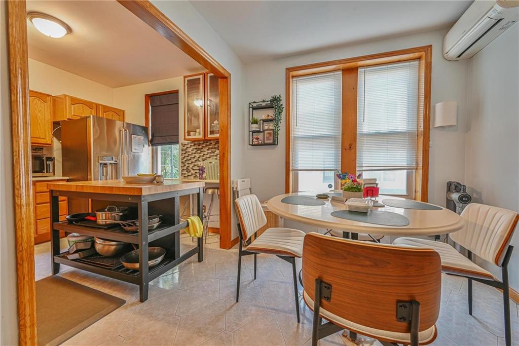 1270 68th Street Brooklyn, NY 11219 - Photo 5 of 20 a dining room with furniture and a floor to ceiling window