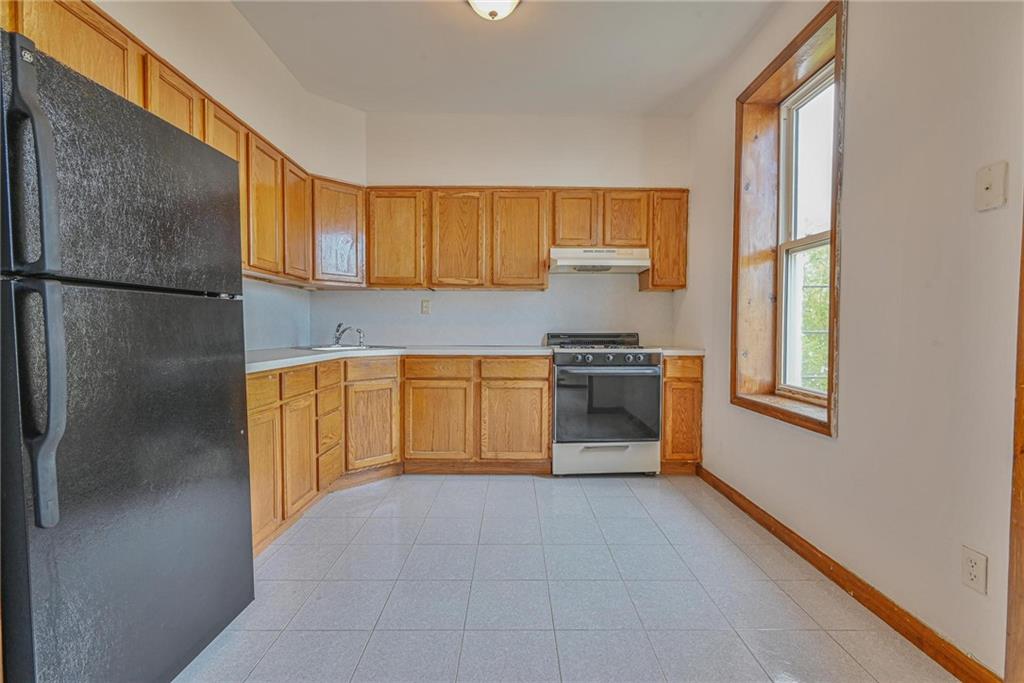 1270 68th Street Brooklyn, NY 11219 - Photo 6 of 20 a kitchen with stainless steel appliances granite countertop a refrigerator and a sink
