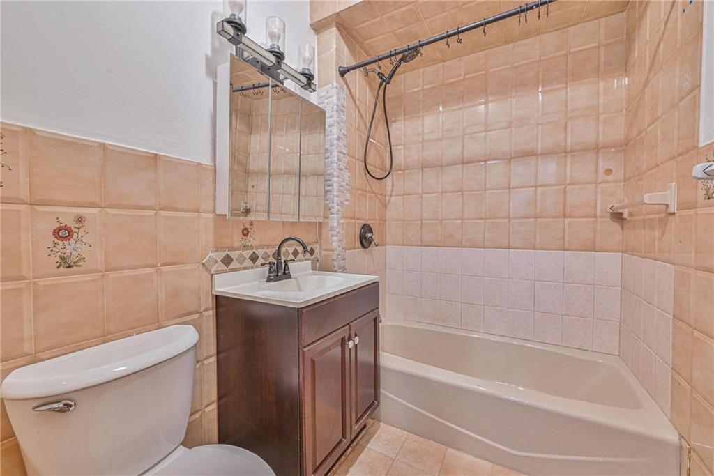 1270 68th Street Brooklyn, NY 11219 - Photo 10 of 20 a bathroom with a granite countertop sink a toilet and shower