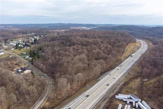 an aerial view of houses covered in trees