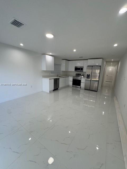 3127 Northwest 60th Street Miami, FL 33142 - Photo 5 of 13 a view of a kitchen with a sink and chairs