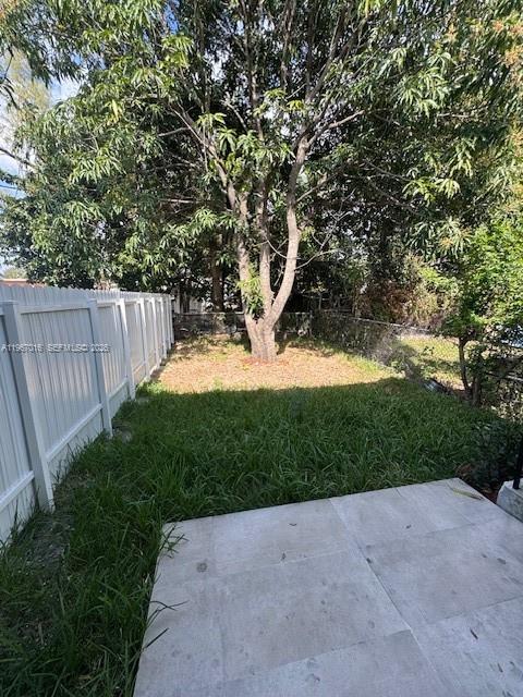 3127 Northwest 60th Street Miami, FL 33142 - Photo 10 of 13 a view of a yard with plants and trees beside of it