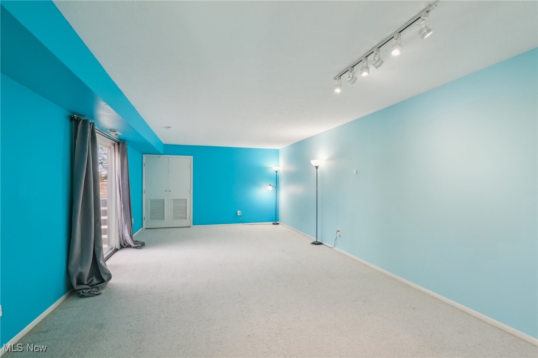 3484 Mayfield Road, Unit 3426 Cleveland Heights, OH 44118 - Photo 26 of 33 Unfurnished room featuring baseboards, carpet flooring, and rail lighting
