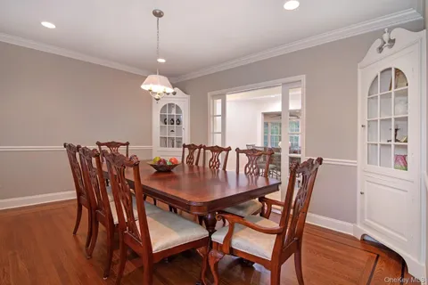 a dining room with furniture window and wooden floor